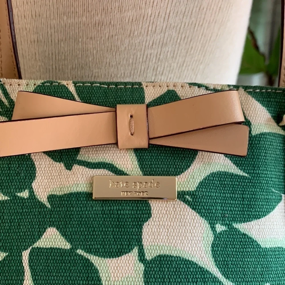 Kate Spade cream colored cloth tote with green leaf pattern.
